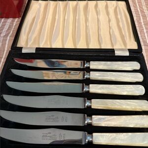 B Thomas & Co vintage Sheffield steak knives with pearl handles.